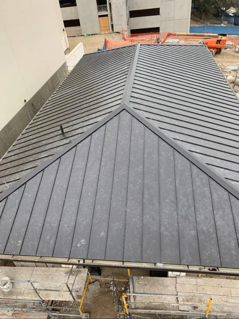 Commercial metal roof construction with crane equipment in Bermuda Dunes